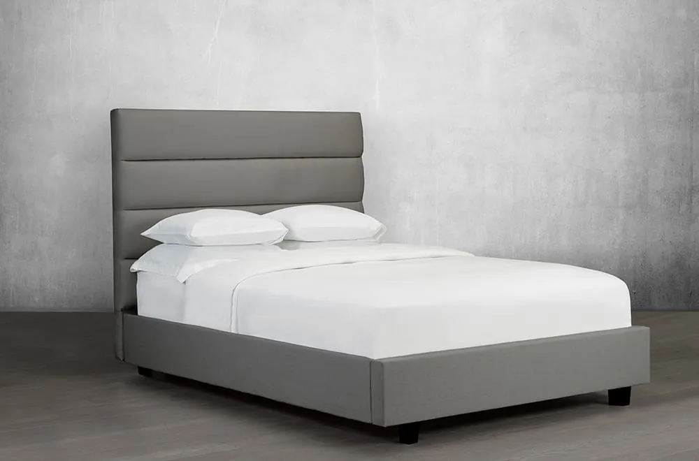 Upholstered Bed Featuring lofty tufted panels
